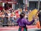 Woman dressed in traditional Mexican wear waves fans in front of