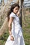 Woman dressed in white in a wasteland of abandoned crops