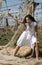 Woman dressed in white in a wasteland of abandoned crops