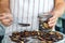 Woman dried plums in a dehydrator into jars. Selective focus.