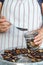 Woman dried plums in a dehydrator into jars. Selective focus.