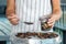 Woman dried plums in a dehydrator into jars. Selective focus.