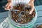 Woman dried plums in a dehydrator into jars. Selective focus.