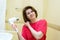 Woman dries hair a hair dryer in a bathroom