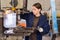 Woman drilling steel structures on drill press