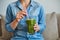 Woman drink healty smoothie with green vegetables