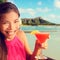 Woman drinking cocktail alcohol drink at beach bar