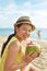 Woman drinking coconut water having fun on summer