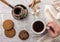 Woman drinking coffee with cookies top view