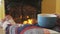 Woman Drinking Coffee Cup by Fireplace In Winter Cozy With Blanket Cover