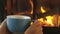 Woman Drinking Coffee Cup By Fireplace In Winter In Slow Motion