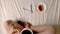Woman is drinking coffee and making plans on day, top view hd video