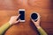 Woman drinking coffee and touching phone screen by finger.