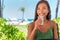 Woman drinking cold water drink glass at outdoor cafe hotel resort on beach holidays. Healthy girl staying hydrated during warm