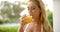 Woman Drinking Glass of Orange Juice Outdoors