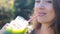Woman is drinking green smoothies close-up. Concept of detox, diet, vegetarianism, healthy lifestyle.
