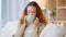 Woman drinking a hot cup of tea or coffee at home. Carefree, relaxed and cheerful young female smelling the aroma of a