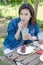 Woman drinking ice greentea and cake