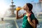 Woman drinking juice near the fountain