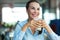 Woman drinking latte macchiato at cafe