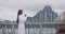 Woman drinking morning coffee relaxing wearing bathrobe looking at view of ocean and Mount Otemanu on Bora Bora, French