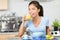 Woman drinking orange juice eating breakfast