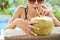 Woman drinking refreshing coconut cocktail