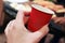 Woman drinking take away coffee cup in coffee shop