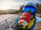 woman drinking tea on the top of snowed mountain. reflection in ski mask. winter sport lifestyle