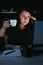 Woman drinking too much coffee at night work