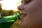 woman drinking water from a bottle face closeup enjoyment summer