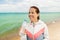 Woman drinking water after exercising on beach