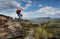 Woman drinking water on mountain summit Australia