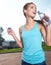 Woman drinking water at outdoors workout