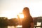 Woman drinking a wine in the city during a sunset. Glass of red wine. Concept of free time in the city and drinking alcohol.