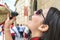 Woman drinking wine in a traditional way at caballos Del Vino in Caravaca de la Cruz, Spain on May 2nd 2019