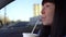 Woman drinks a drink through a straw. Slow motion