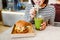 Woman drinks green smoothies and eats a burger in a vegan fast food restaurant