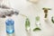 Woman dripping sample into bottle with plant on table in laboratory