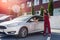 Woman driver and agent exchanging by dollars and car keys