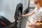 Woman driver hand inflating tires of vehicle, checking air pressure and filling air on car wheel at gas station. self service,