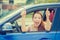 Woman driver happy smiling showing thumbs up sitting inside new car