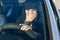 Woman driver scared while driving covered her mouth with her hand