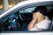 Woman driver scared shocked before crash or accident closing her eyes in her car