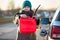 Woman a driver showing plastic can due tank empty of petrol, person standing close to opened cap, winter season