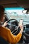 woman driver using mobile phone screen blank mockup on the road while driving a car