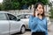 Woman drivers call insurance after a car accident before taking pictures and sending insurance. Online car accident insurance