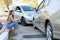 Woman drivers call insurance after a car accident before taking pictures and sending insurance. Online car accident insurance