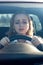 Woman drives her car for the first time, tries to avoid a car accident, is very nervous and scared, worries, clings tightly to the