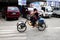 Woman drives a pedal powered quad bike at a public parking area